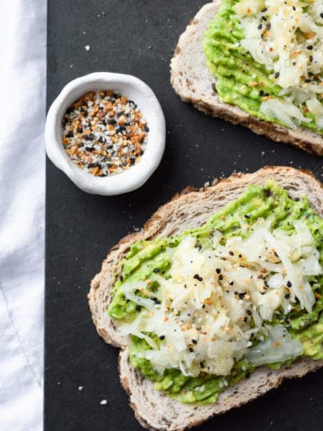avocado toast with sauerkraut and a bowl of everything but the bagel seasoning