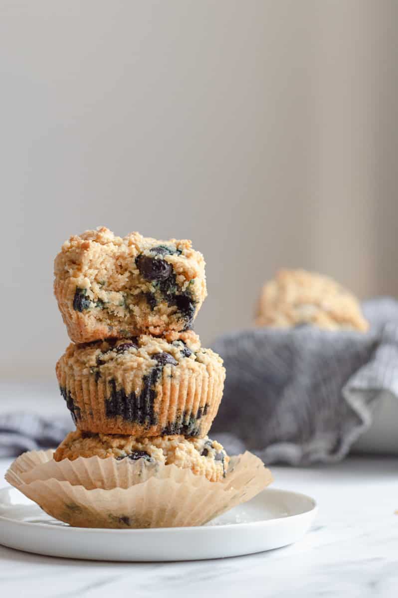 3 gluten-free dairy-free blueberry muffins stacked on top of each other