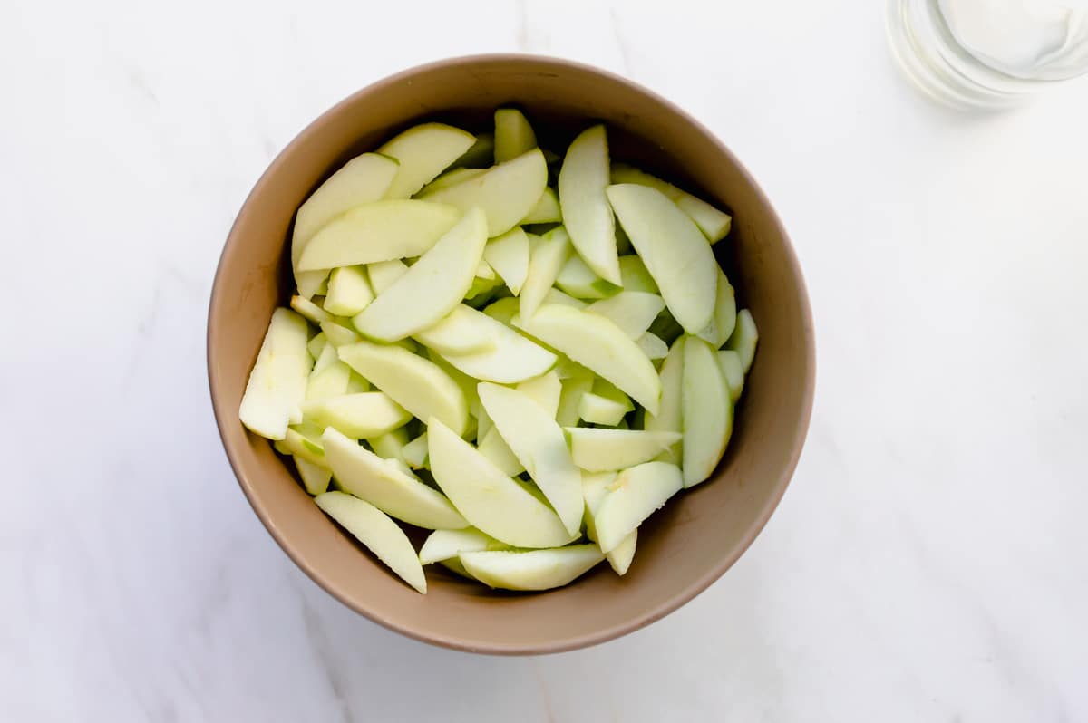 apple slices in a beige bowl