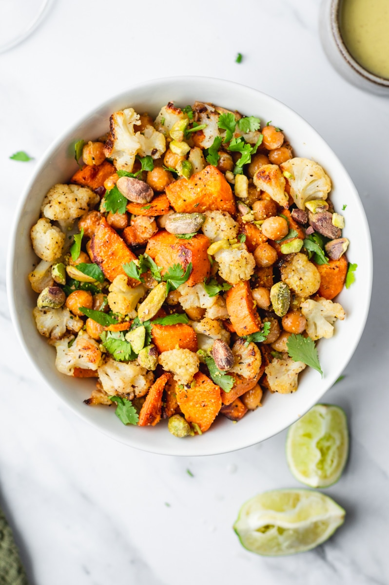 oven roasted sweet potato, chickpea, and cauliflower topped with cilantro and pistachios