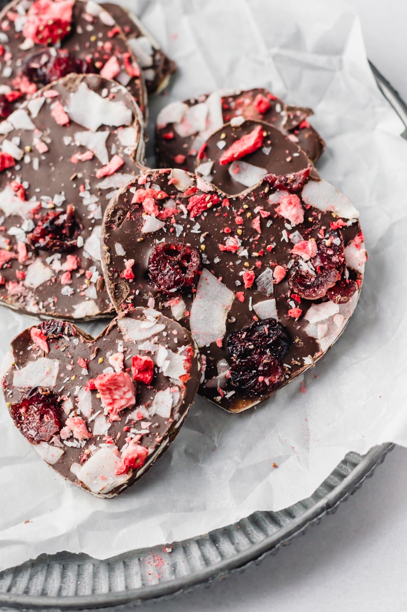 vegan valentine chocolate bark with cranberries, strawberries, and coconut flakes