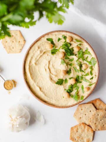 easy homemade hummus with canned chickpeas topped with parsley and oil