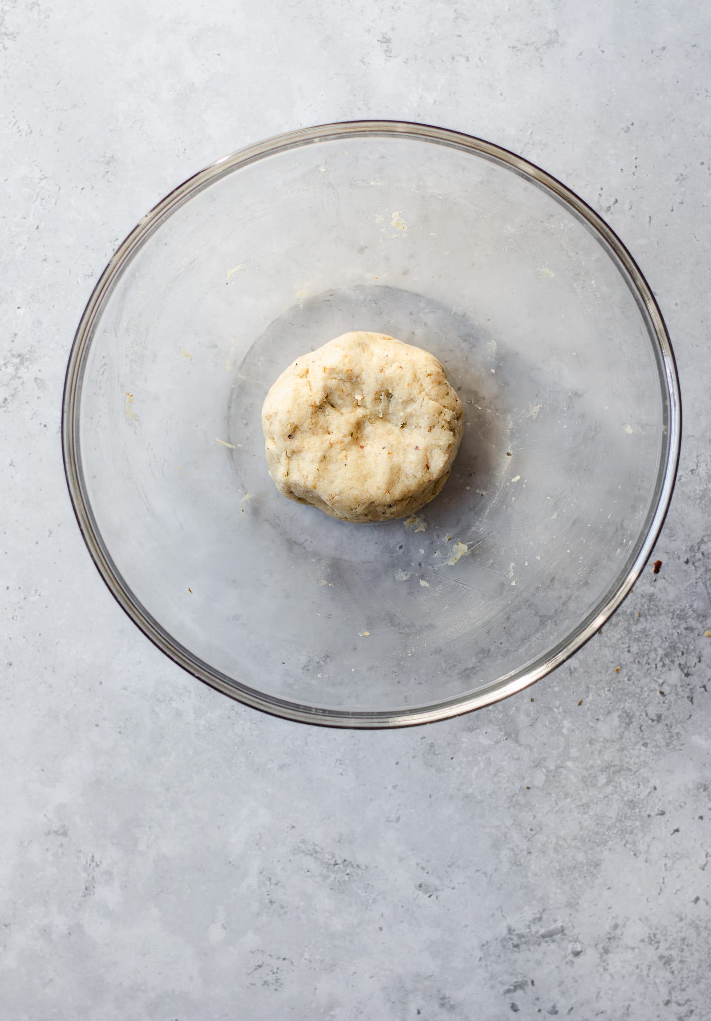 vegan gluten-free flatbread pizza dough formed into a ball in a mixing bowl