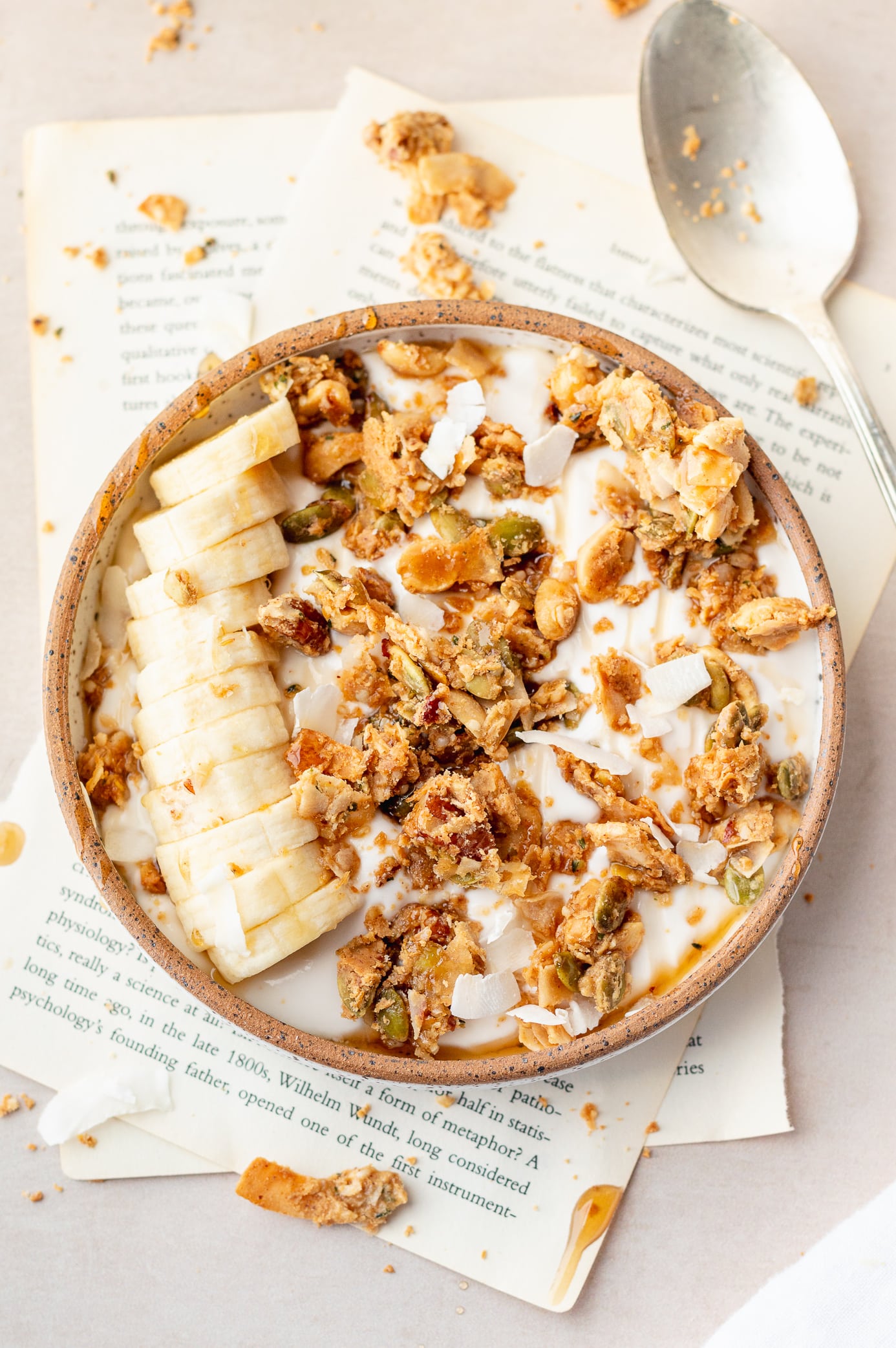 coconut peanut butter granola with sliced banana and yogurt
