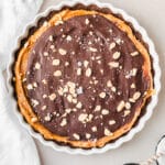 vegan peanut butter cup tart topped with chocolate and peanuts