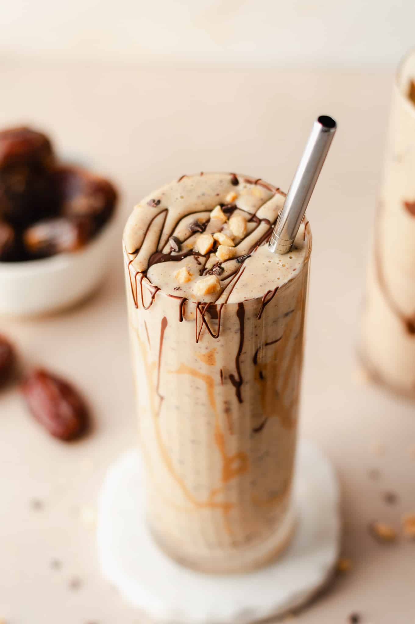 snickers protein smoothie topped with chocolate and peanuts
