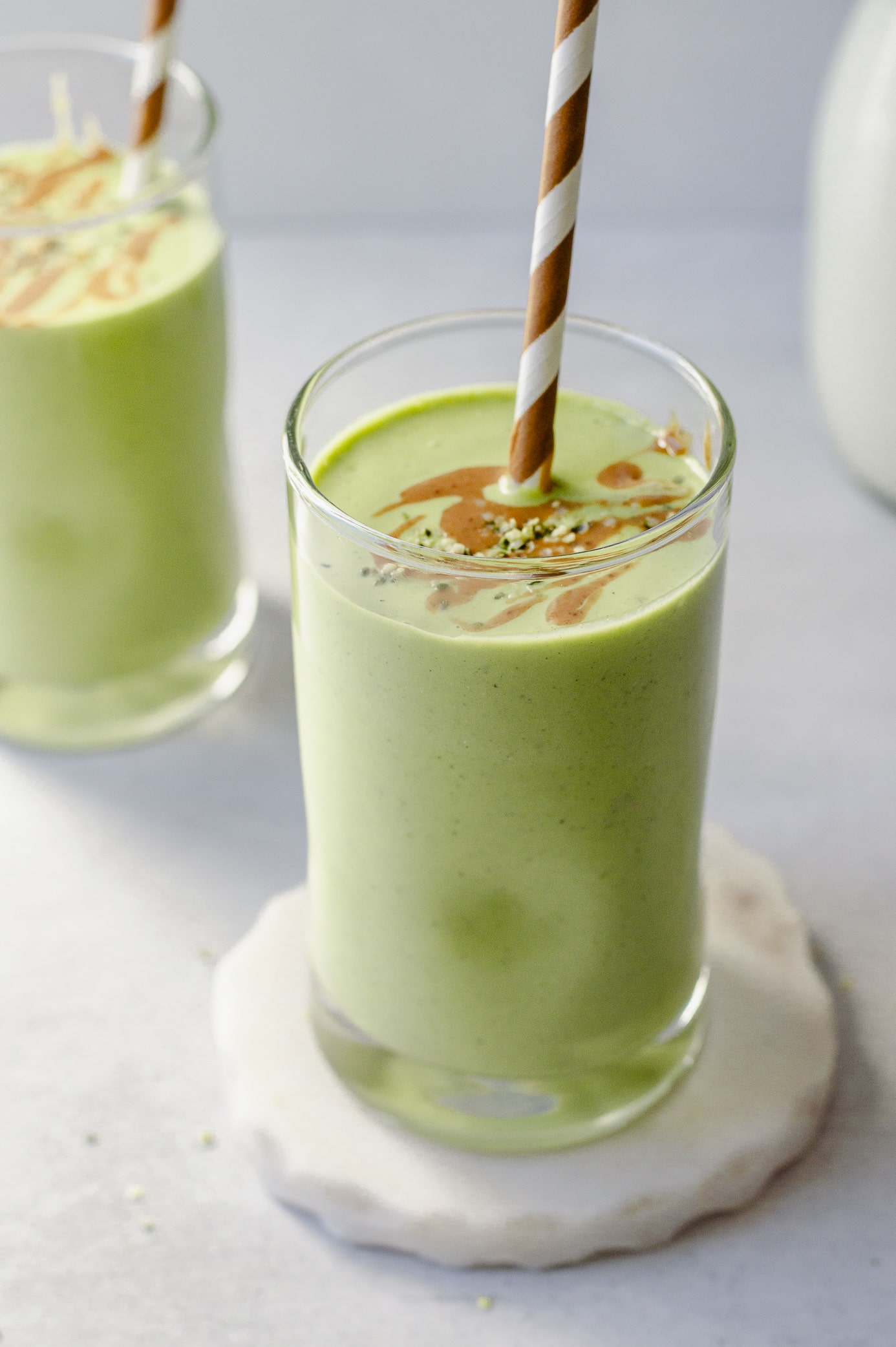 Peanut butter green smoothie made with spinach and banana in a glass
