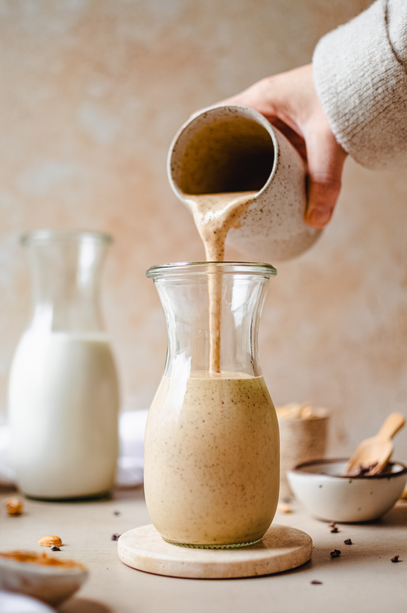 Pouring a chunky monkey smoothie into a glass