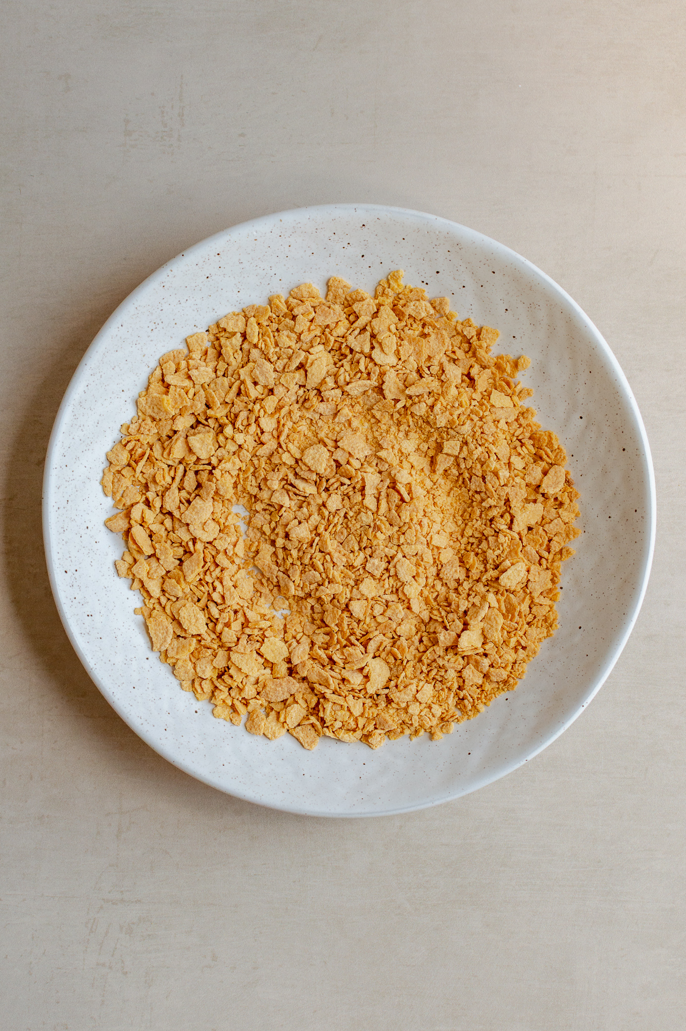Crushed gluten-free cornflakes in a bowl for homemade vegan Butterfingers