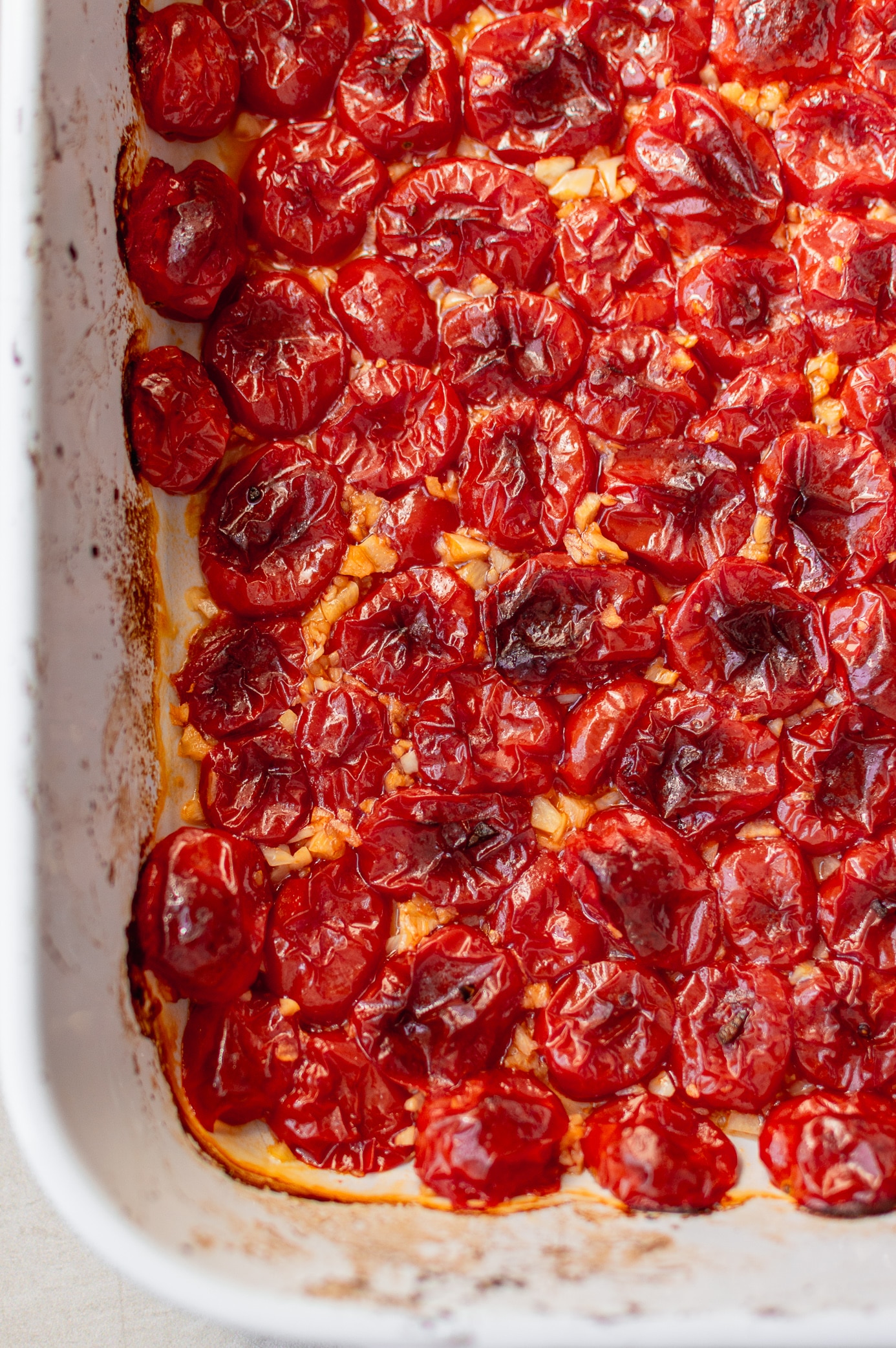 Roasted grape tomatoes with garlic in a baking dish
