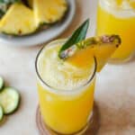 Pineapple cucumber juice served over ice and garnished with fresh pineapple and pineapple stem