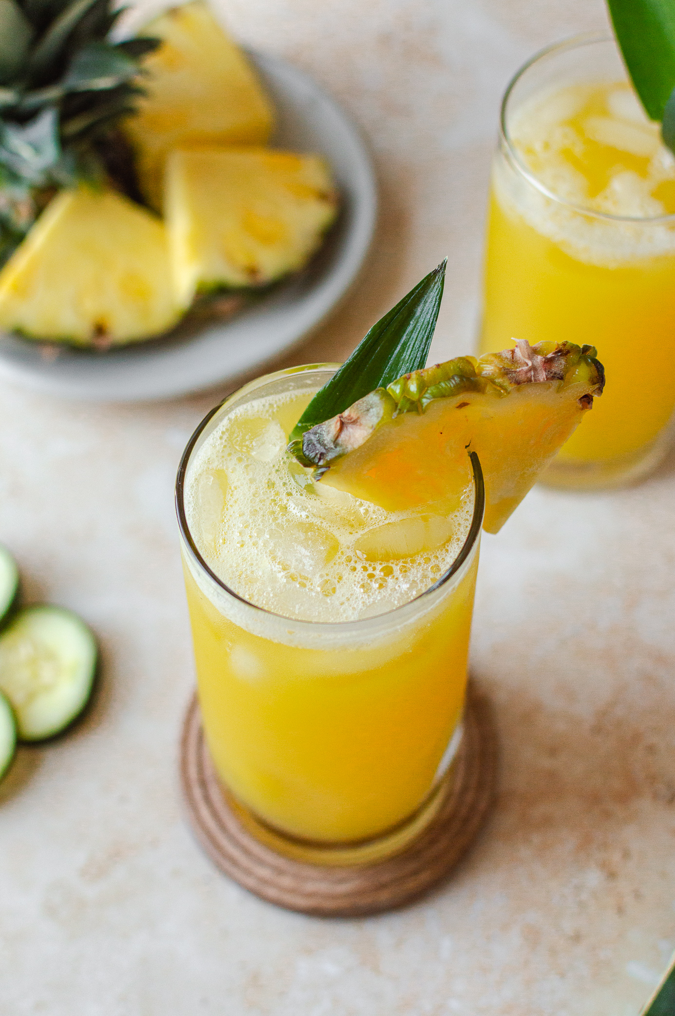 Pineapple cucumber juice served over ice and garnished with fresh pineapple and pineapple stem