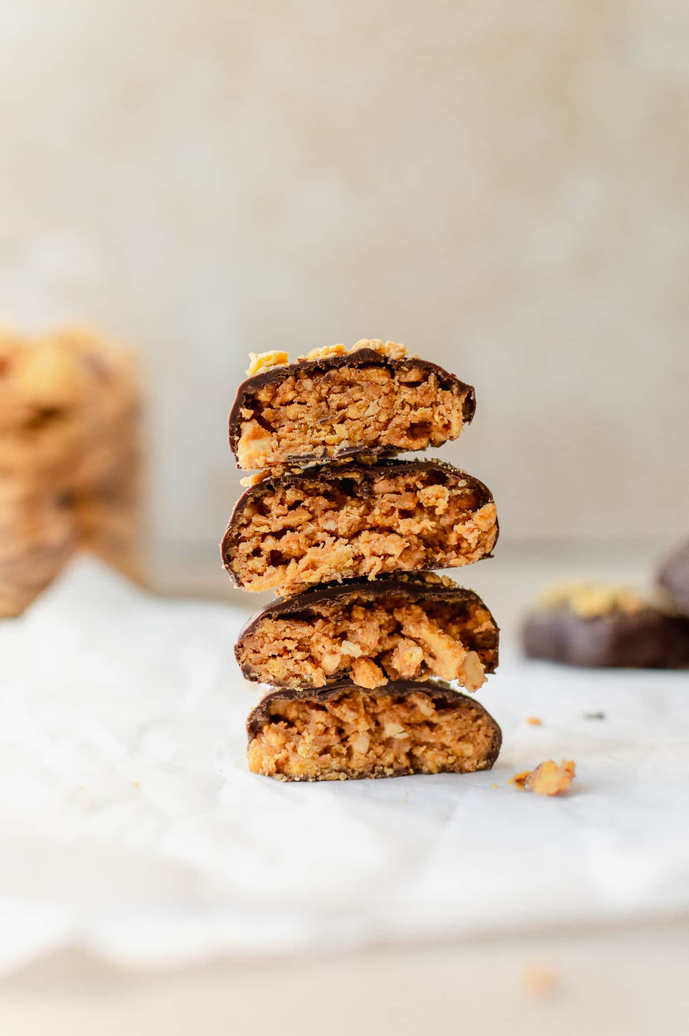 Chocolate-coated vegan Butterfingers cut in half to show the crunchy cornflake peanut butter filling