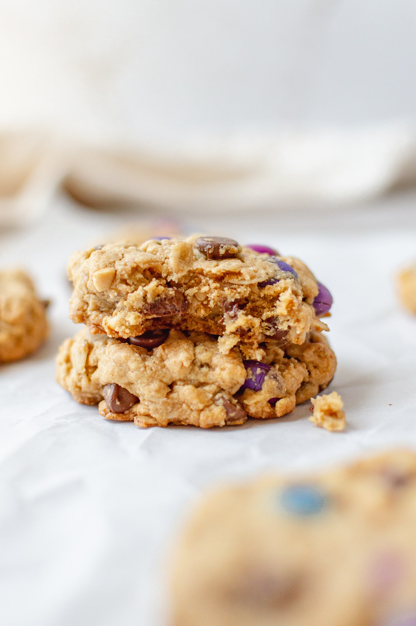 stack of two monster cookies with a bite taken out of one showing the cookie texture