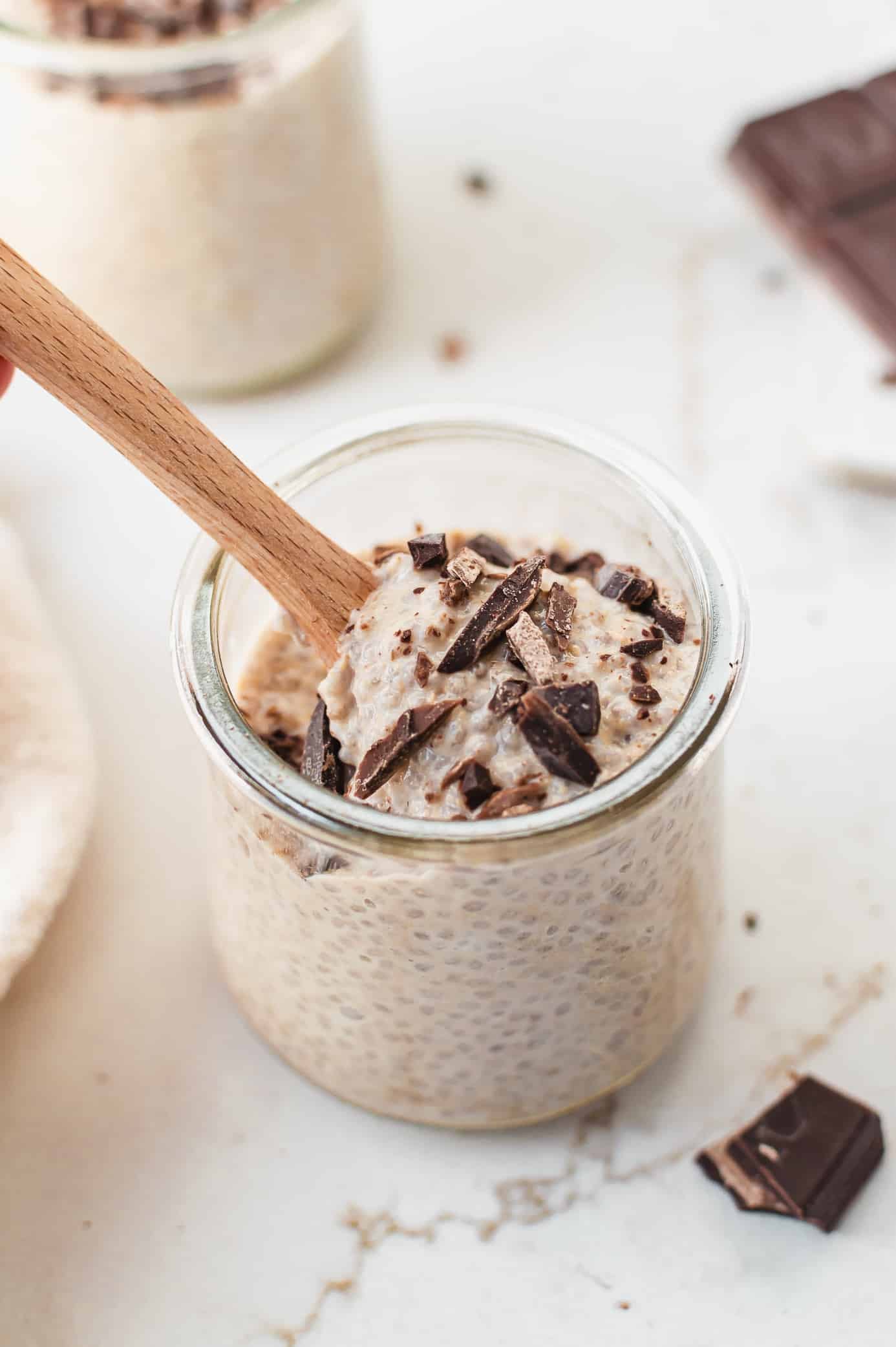 Spoonful of thick cookie dough chia pudding lifted from a glass jar.